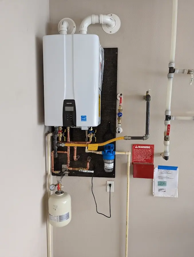 Professional plumber installing copper piping in a Eunice home